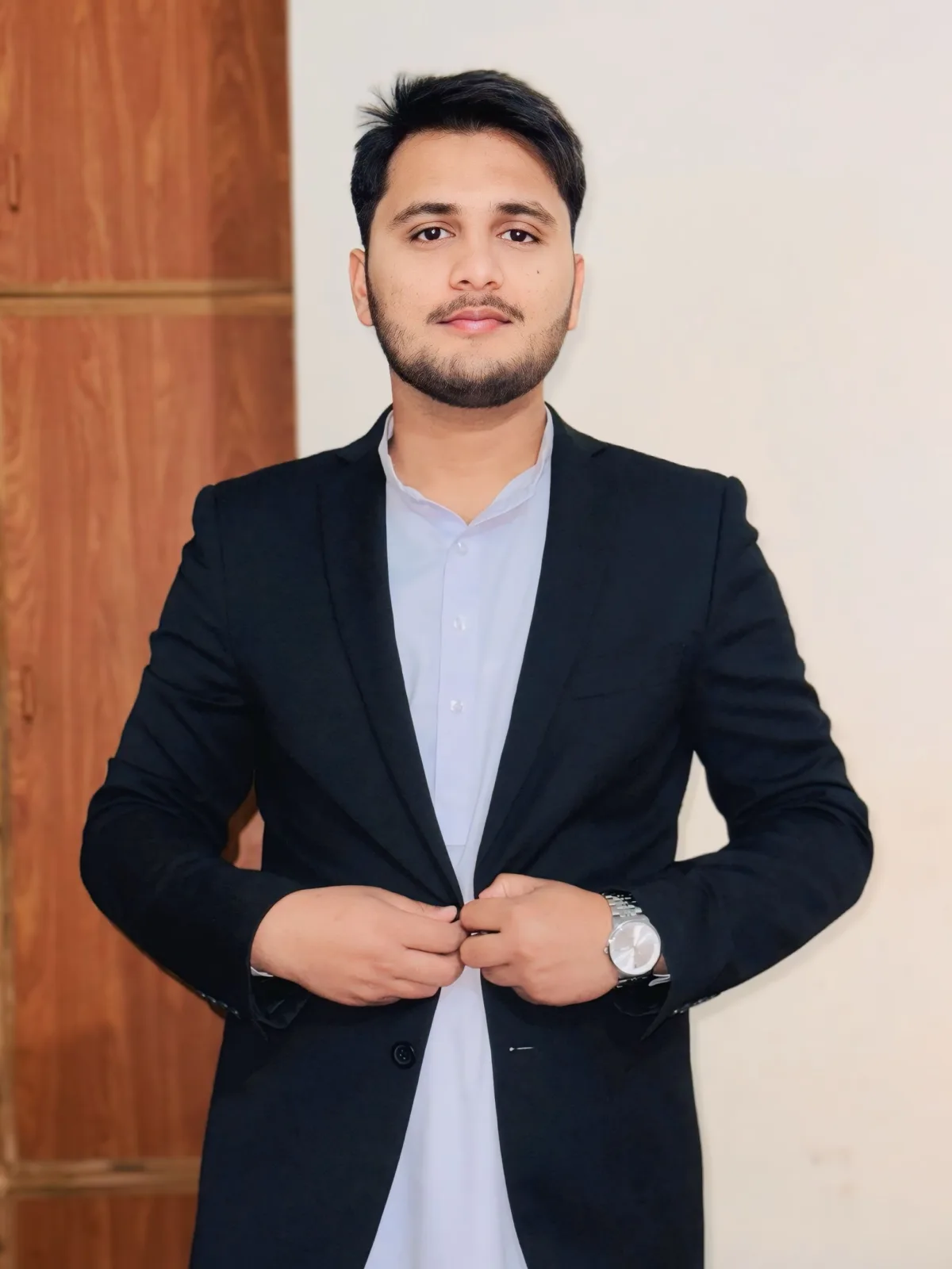 Fahad Naeem wearing a black suit for a professional software developer portrait